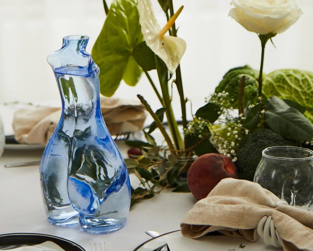 Anissa Kermiche blue sculpted glass carafe on a dinner table